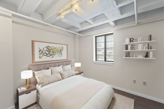 a bedroom with a large bed and a window