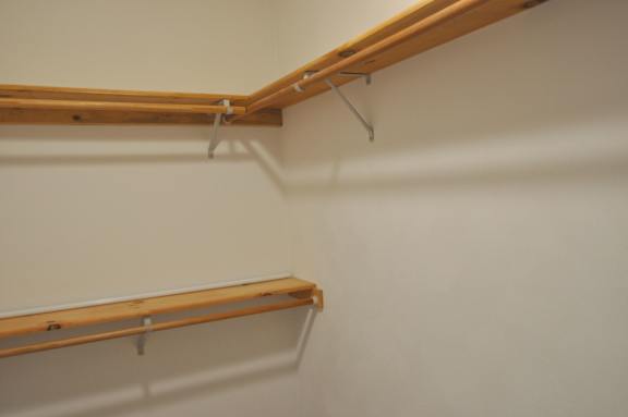 A wall with two shelves on it.