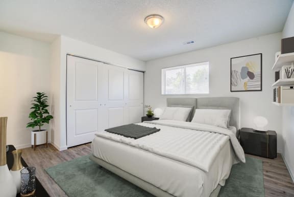a bedroom with a white bed and a large white door