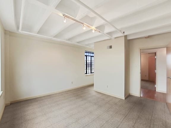 an empty room with white walls and a carpeted floor