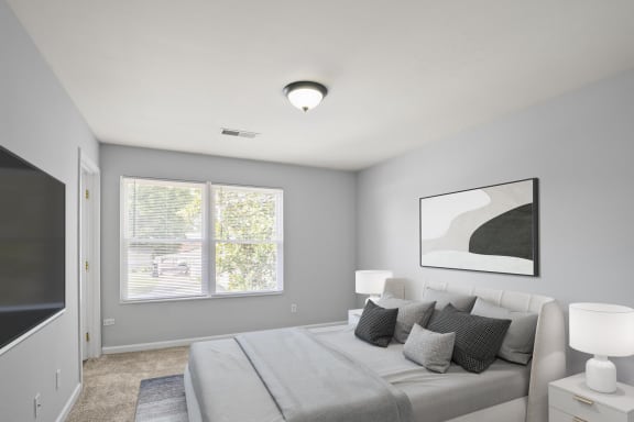 a bedroom with a large bed and a large window