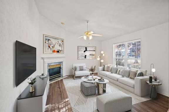 A modern living room with a fireplace and a flat screen TV.