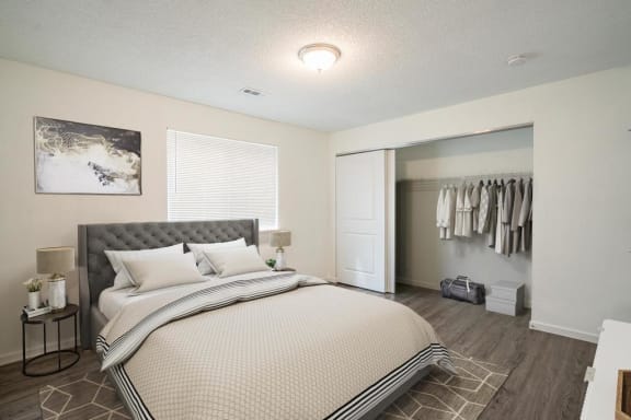 a bedroom with a large bed and a closet
