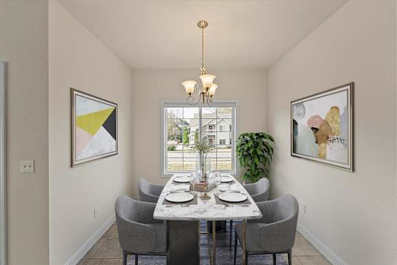 a dining room with a table and chairs and a window