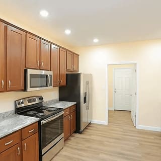 A kitchen with wooden cabinets and stainless steel appliances.
