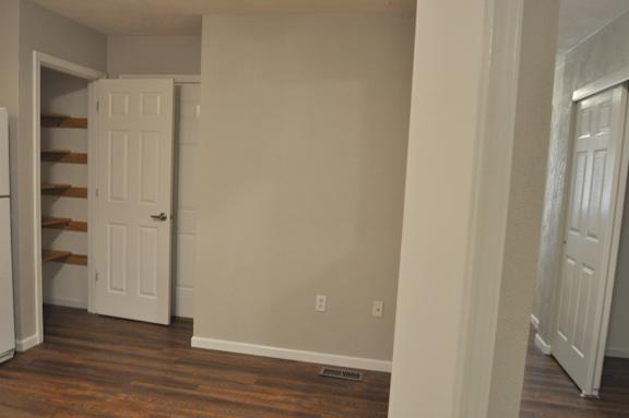 A white door is open to a hallway.