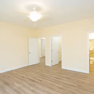 A room with white doors and a ceiling light.