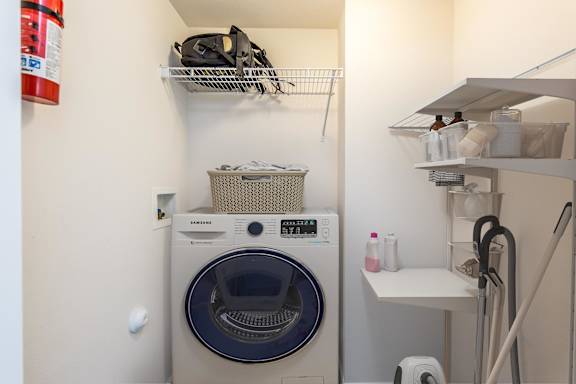 A small laundry room with a washer and dryer.
