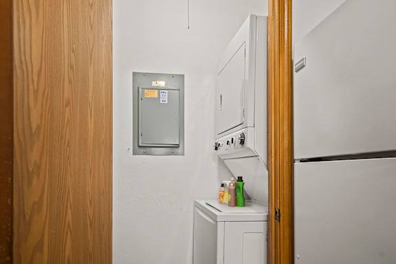 A small kitchen with a white fridge and a white oven.