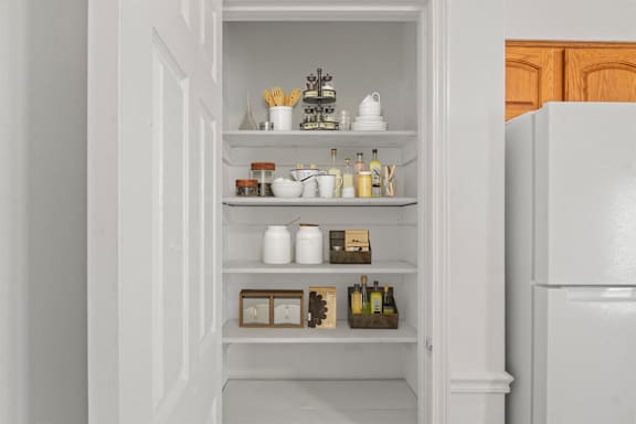 A white refrigerator with a few items on the shelves.