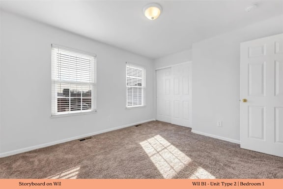 A white bedroom with a window and a door.