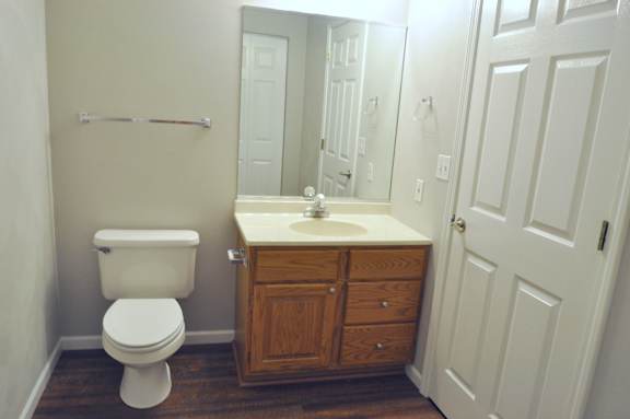 A white toilet sits next to a sink in a bathroom.