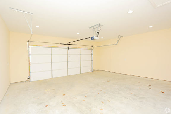A room with a white ceiling and a white door with a window above it.