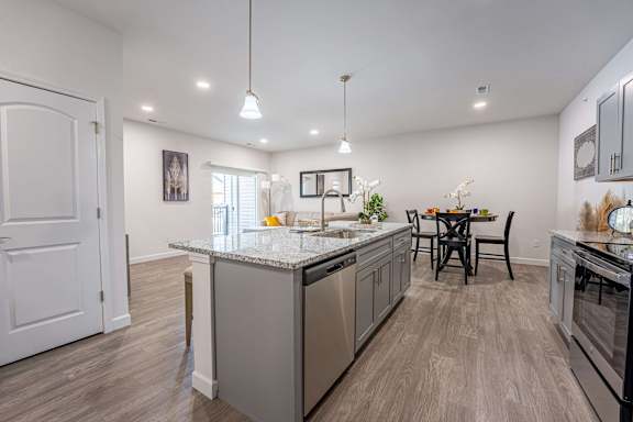 A kitchen with a table and chairs in the middle of the room.