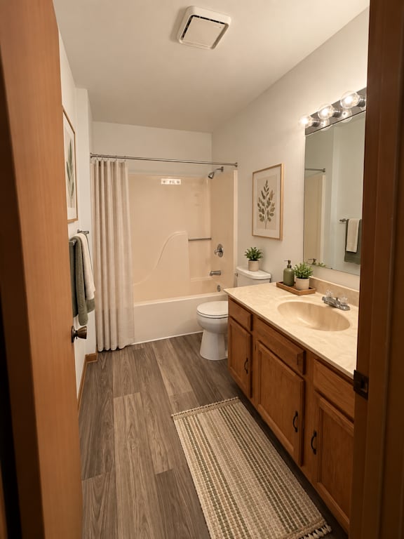 A bathroom with a toilet, sink, and shower.