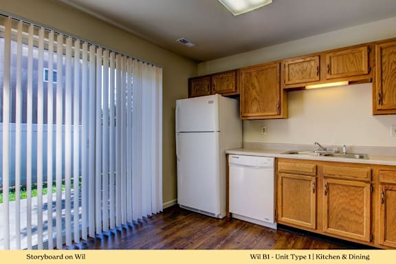 A kitchen with wooden cabinets and a white refrigerator.