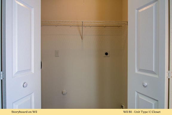 A white closet with a door on the left and a door on the right.