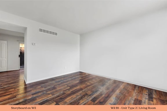 A living room with wooden floors and white walls.