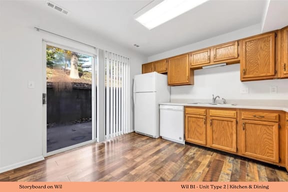 A kitchen with wooden cabinets and a white fridge.
