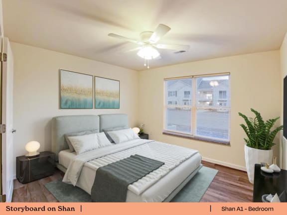 a bedroom with a large bed and a ceiling fan