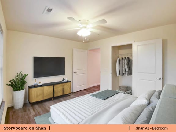 a bedroom with a large bed and a tv