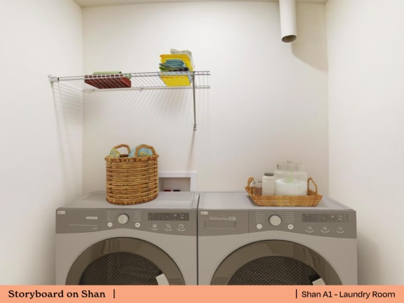 a laundry room with washing machines and baskets