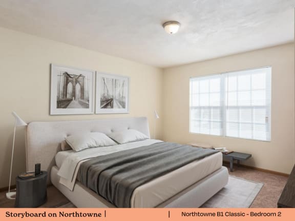 A bedroom with a large bed and two pictures on the wall.