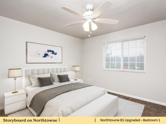 A bedroom with a bed, nightstand, and a ceiling fan.
