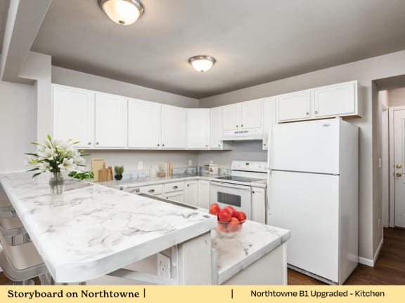 A kitchen with white cabinets and appliances.