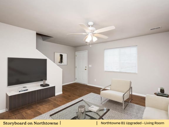 A living room with a television, chair, and coffee table.