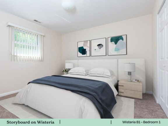 a white bedroom with a bed and three pictures on the wall