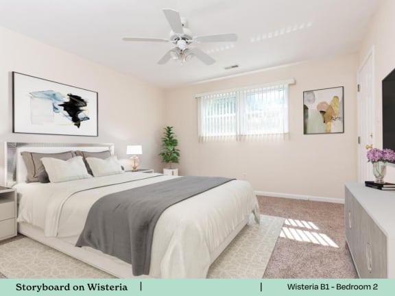 A bedroom with a bed, a ceiling fan, and a painting on the wall.