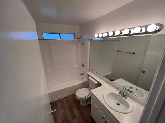 a small bathroom with a sink toilet and shower