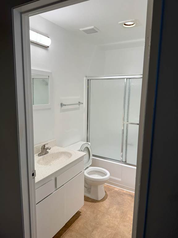 A white sink and toilet in a bathroom.
