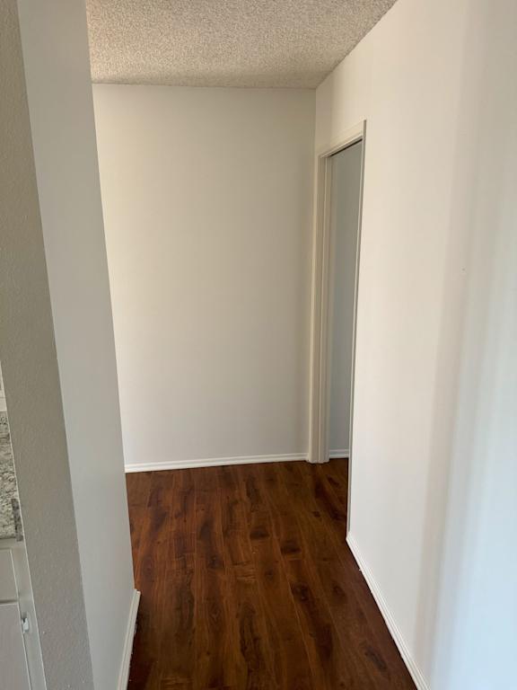 A room with a wooden floor and white walls.