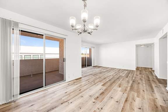 A room with wooden floors and a chandelier.