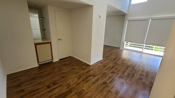 A room with wooden floors and white walls.