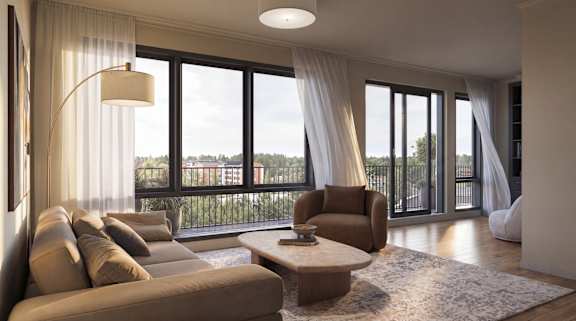 A modern living room with a large window and a view of trees and a fence outside.