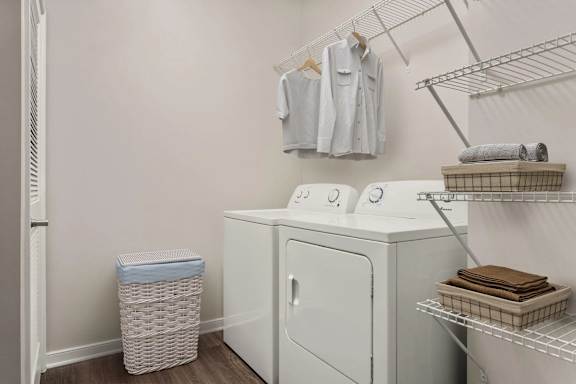 Inunit laundry with storage shelving at Colony at Centerpointe Apartments, Virginia