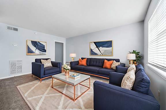 A kitchen with a bar stool and a couch.