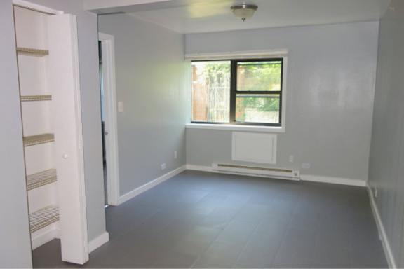 A room with a window and a radiator on the wall.