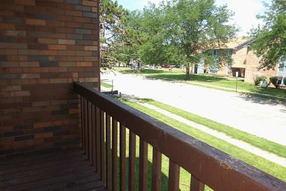 A view from a balcony overlooking a street.
