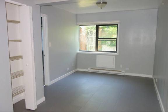 A room with a window and a radiator on the wall.