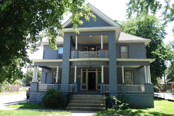 A two-story house with a front porch.