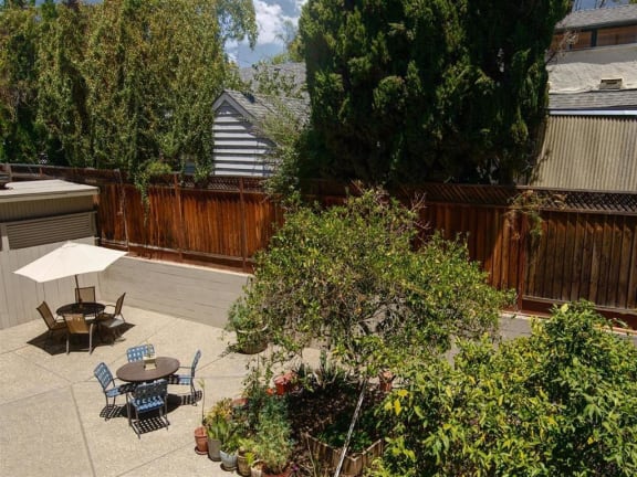 470 resident patio are with tables and chairs and a privacy fence