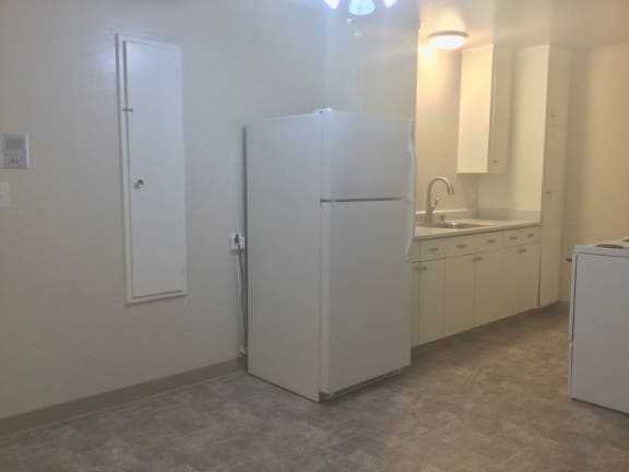 Kitchen with a refrigerator and a sink