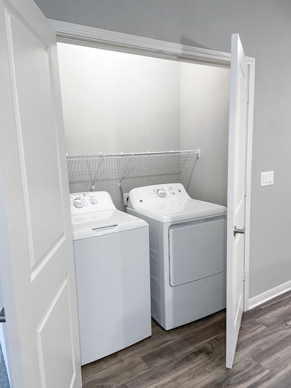 Washer and dryer in a small laundry room at Promenade Luxury Apartments in Beaumont, Texas