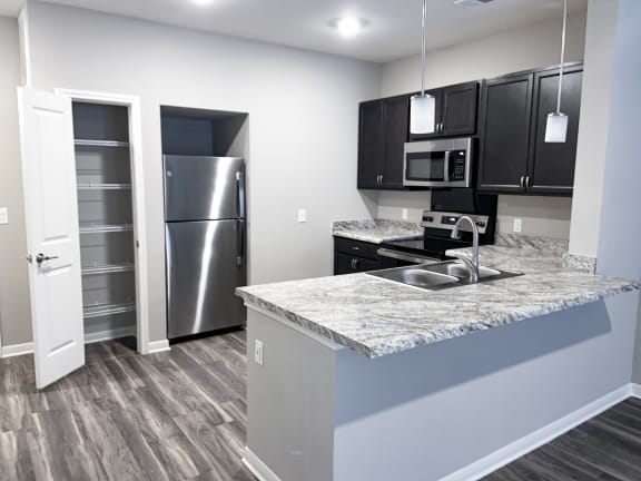 Kitchen with refrigerator and pantry at Promenade Luxury Apartments
