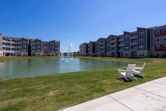 Large pond with a fountain in front of Promenade Luxury Apartments in Beaumont, Texas