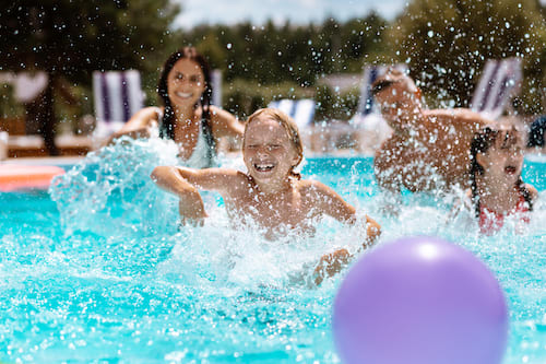 Family splashing water in a pool